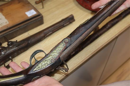 A Continental brass mounted flintlock pistol and another pistol and a rifle rifle 170cm